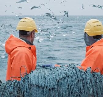 Two men on commercial fishing vessel